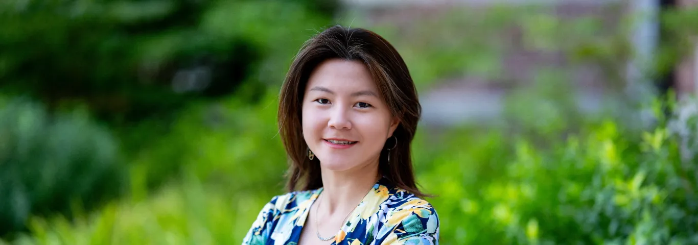 Photo of Victoria Shen smiling to the camera with arms crossed in front of her chest.