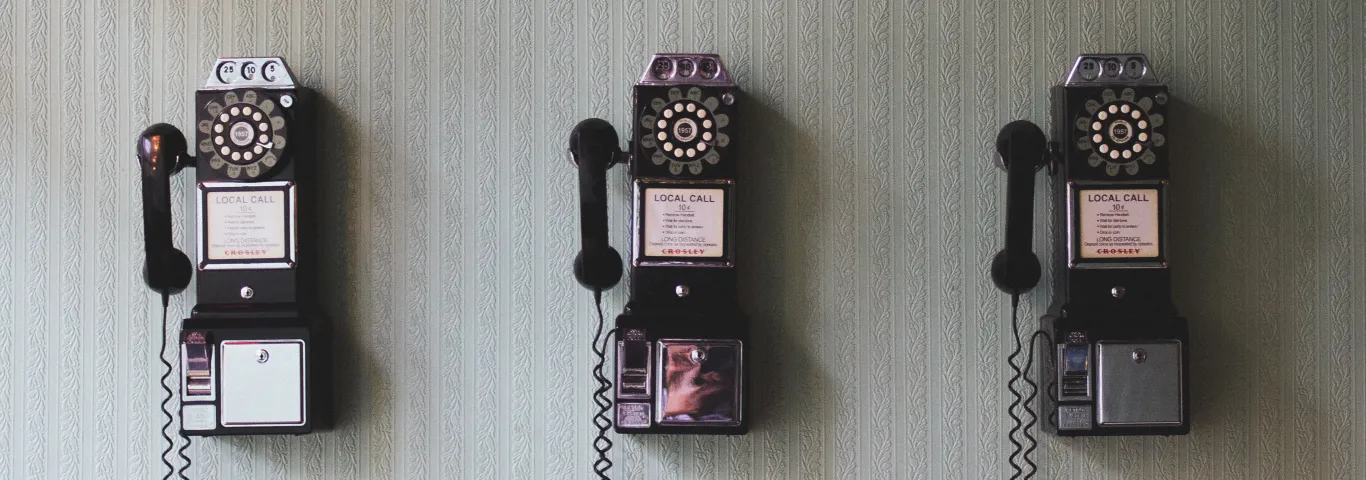 three rotary telephones