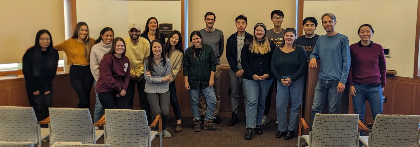 A group of international relations faculty and graduate students gather for a group photo.