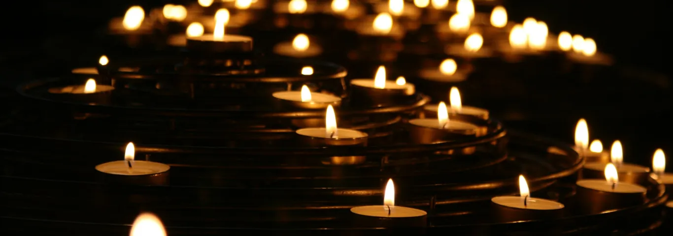 Decorative image of tea candles on a dark background