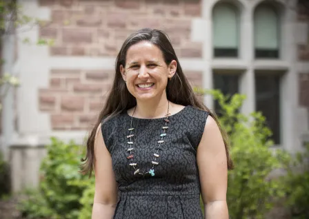 Photo of Department Chair Betsy Sinclair smiling to camera in a dark dress