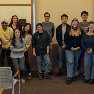 A group of international relations faculty and graduate students gather for a group photo.